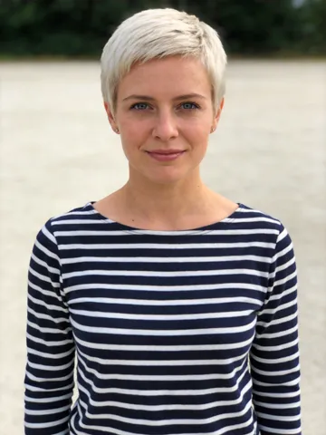 Input photo: a woman with a platinum pixie cut in a striped top