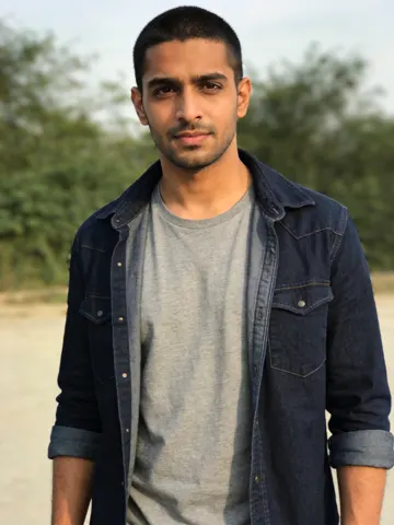 Input photo: a man in a denim jacket